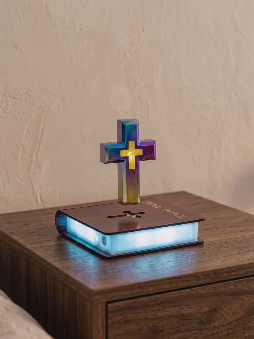The Risen Cross floating and glowing above its base on a nightstand