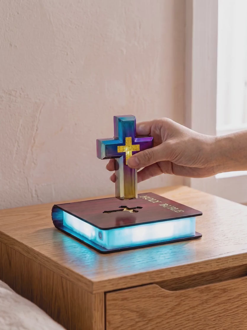 A hand lets go of the cross above the base and it stays in the air