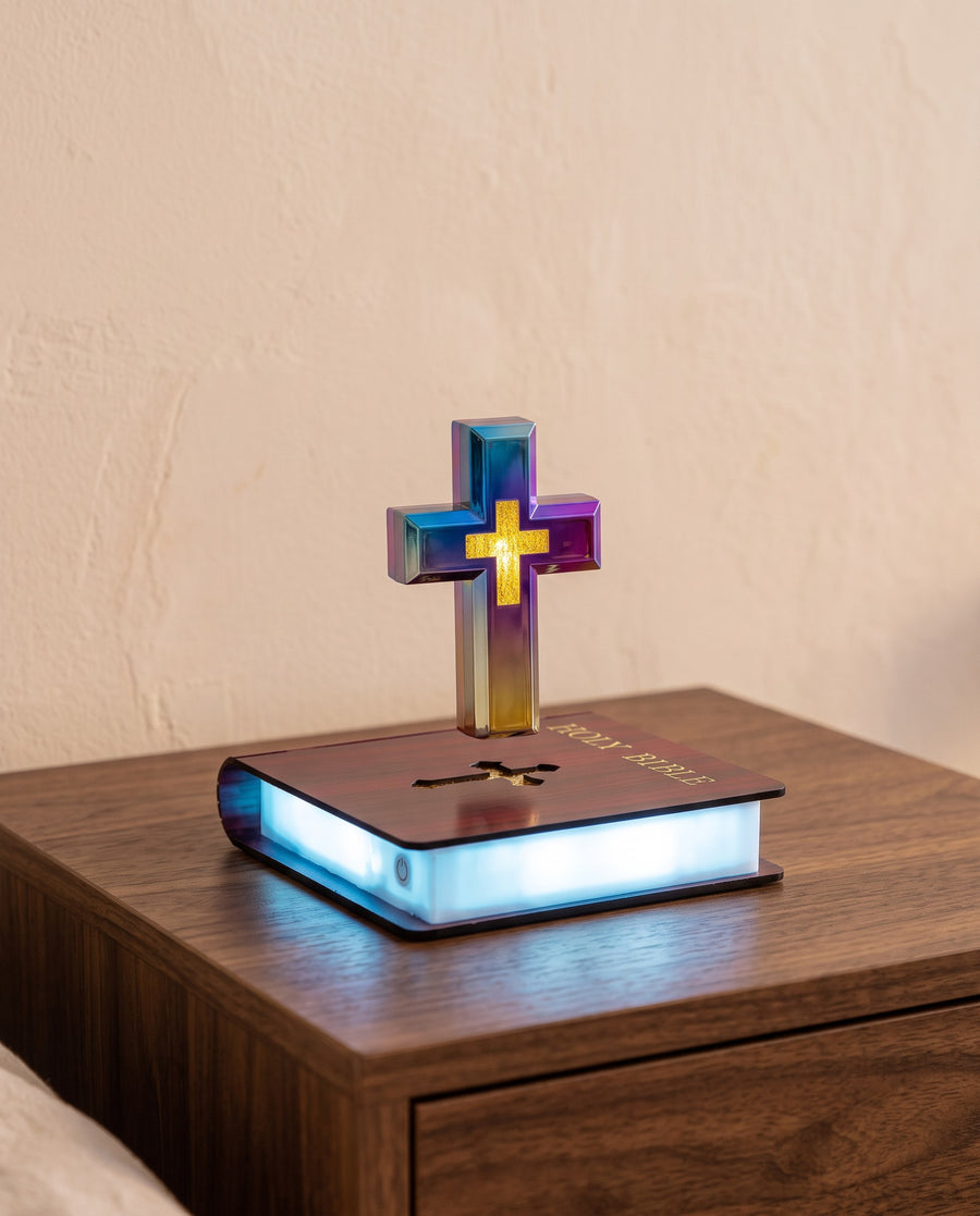 The Risen Cross floating above its Bible-shaped base on a walnut nightstand